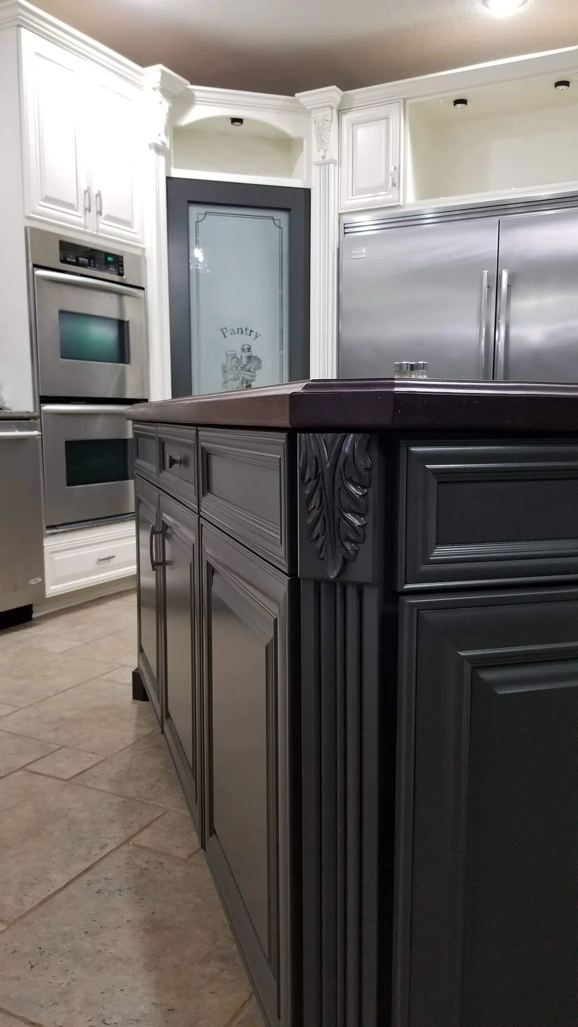 Dark island with white perimeter cabinets