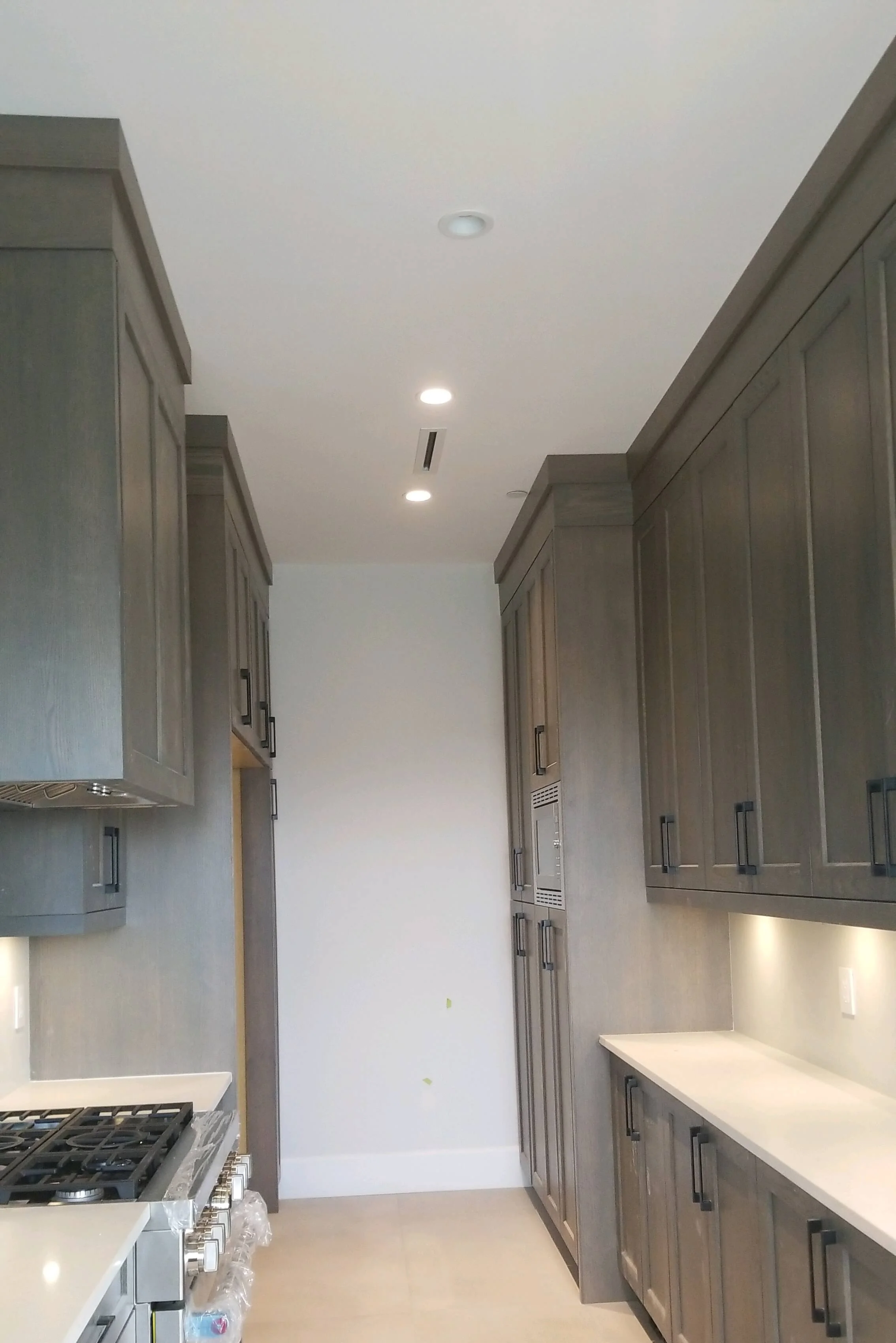 Grey stained galley kitchen cabinets